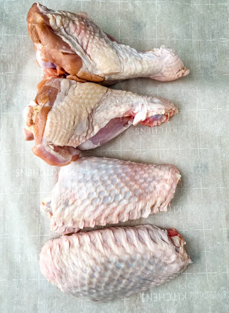 raw turkey wings on parchment paper