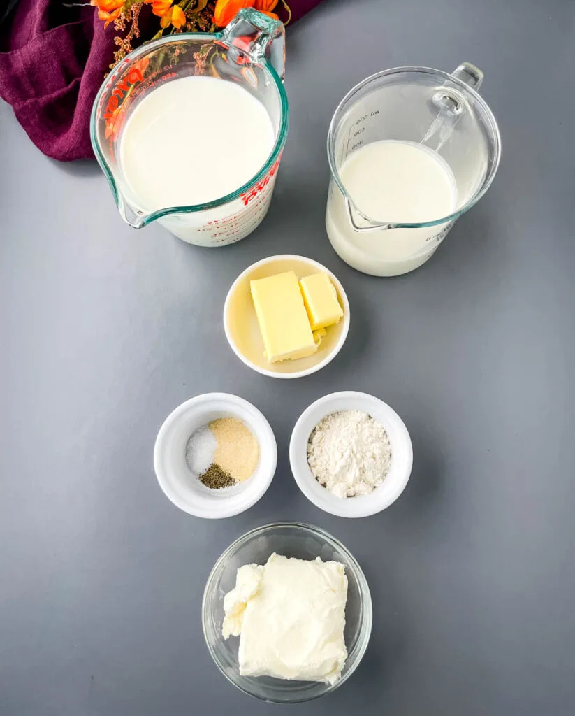 heavy cream, milk, butter, spices, flour, and cream cheese in separate bowls