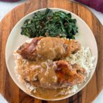 smothered turkey wings and gravy on a plate with white rice