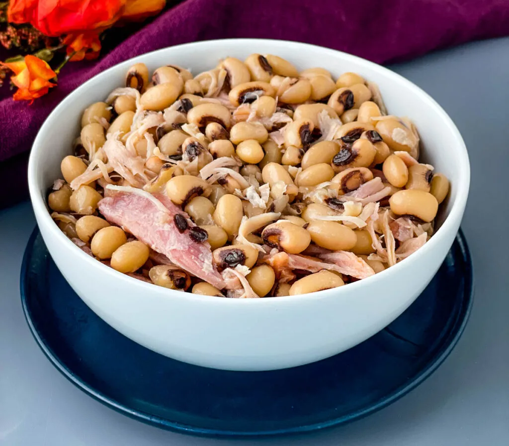 black eyed peas in a white bowl with smoked turkey