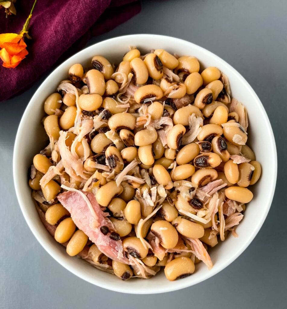 black eyed peas in a white bowl with smoked turkey