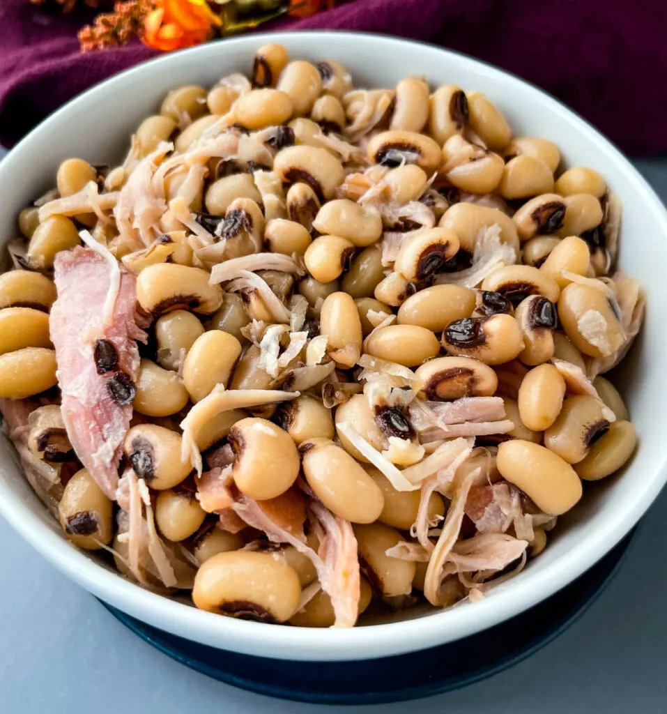 black eyed peas in a white bowl with smoked turkey