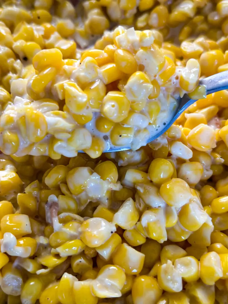 southern creamed corn in a spoon and skillet