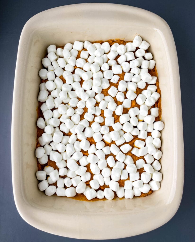 mashed sweet potatoes in a baking dish topped with marshmallows