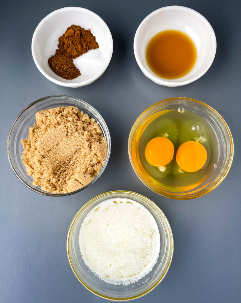 vanilla, spices. sugar, eggs, and sweetener in separate bowls
