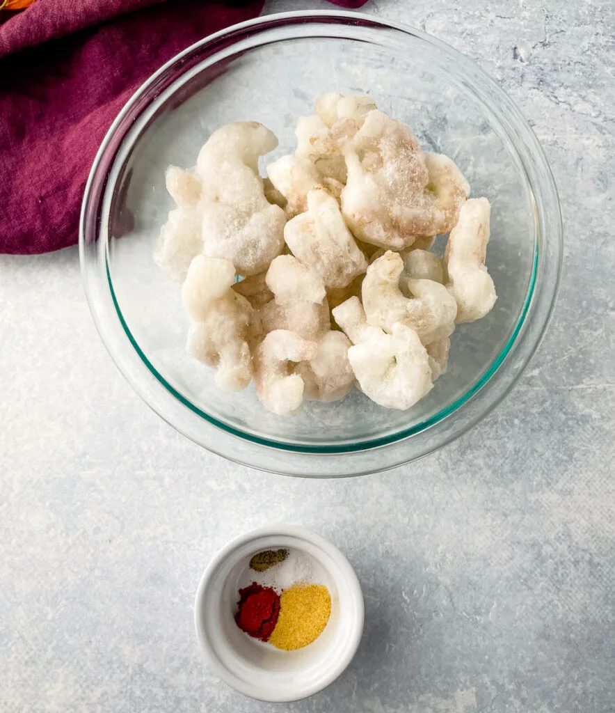 frozen shrimp and spices in separate bowls