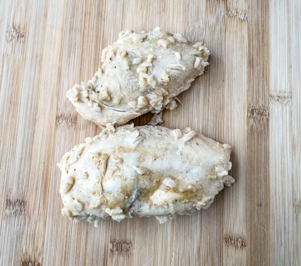 cooked chicken breasts on a cutting board