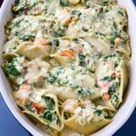 seafood lobster, shrimp, and crab stuffed shells in a baking dish