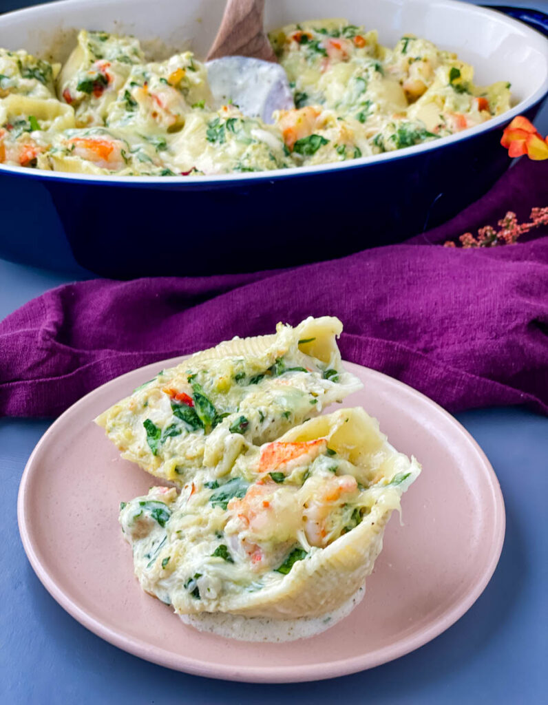 seafood stuffed shells on a pink plate