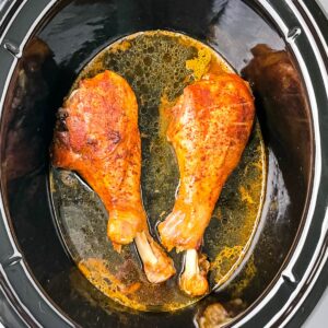 2 cooked turkey legs in a Crockpot slow cooker