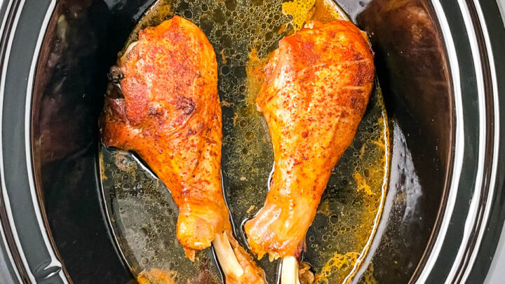 2 cooked turkey legs in a Crockpot slow cooker