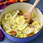 southern soul food cooked cabbage in a large pot with a wooden spoon