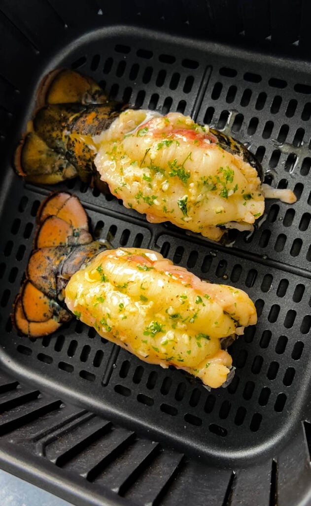 uncooked lobster tails in an air fryer