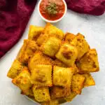 air fryer toasted fried ravioli on a plate with marinara sauce