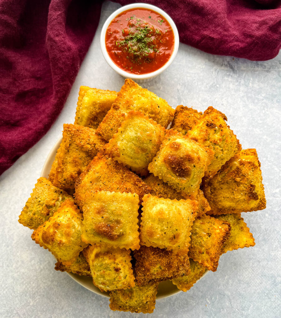 air fryer toasted fried ravioli on a plate with marinara sauce