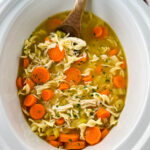 homestyle chicken noodle soup in a white pot