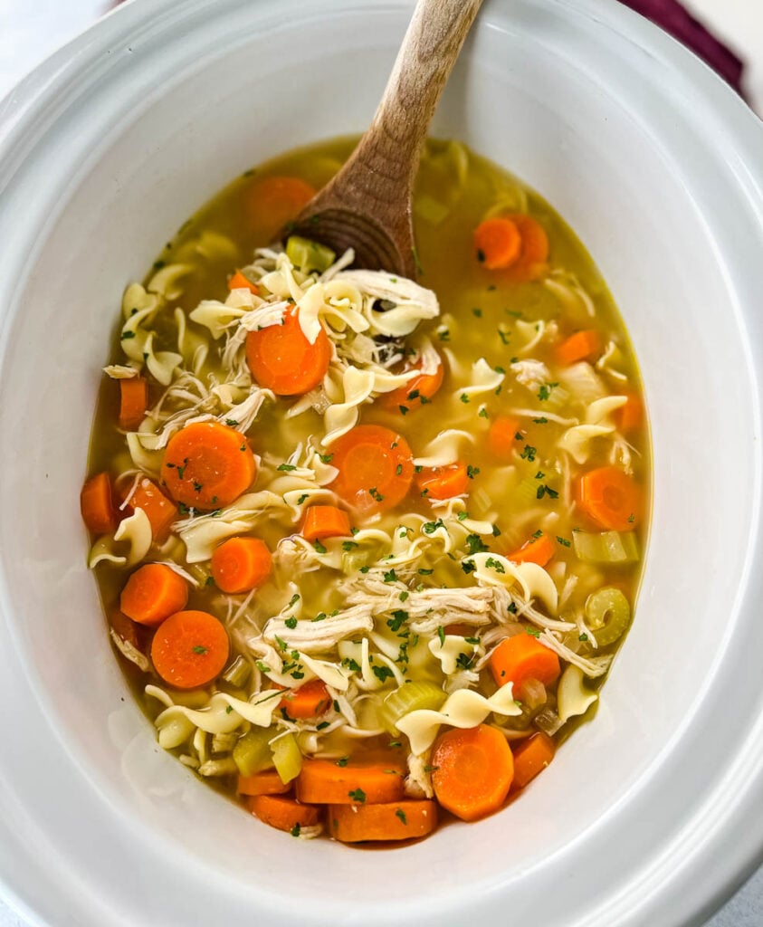 homestyle chicken noodle soup in a white pot