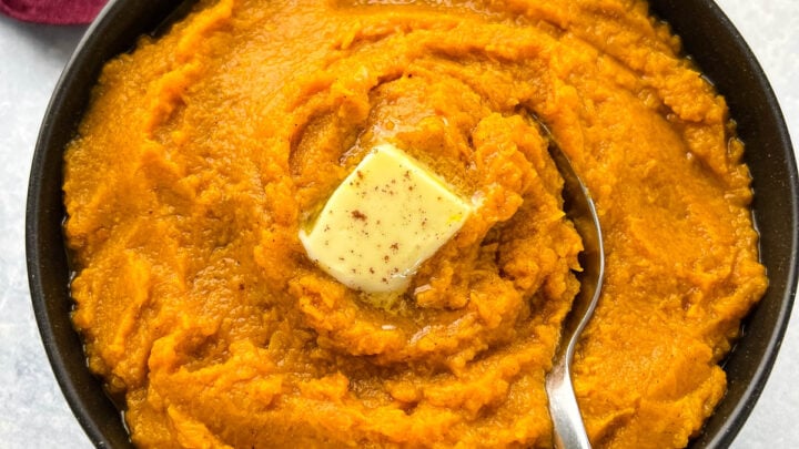 mashed sweet potatoes in a bowl with butter and brown sugar