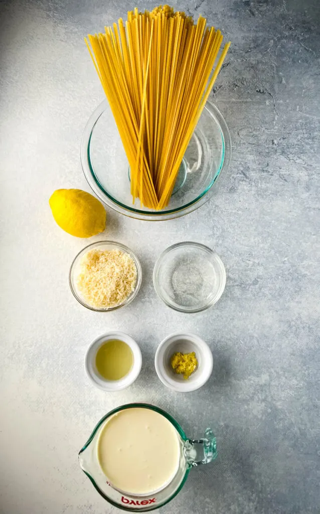 fettuccine, fresh lemon, white wine, heavy cream, and Parmesan in separate bowls