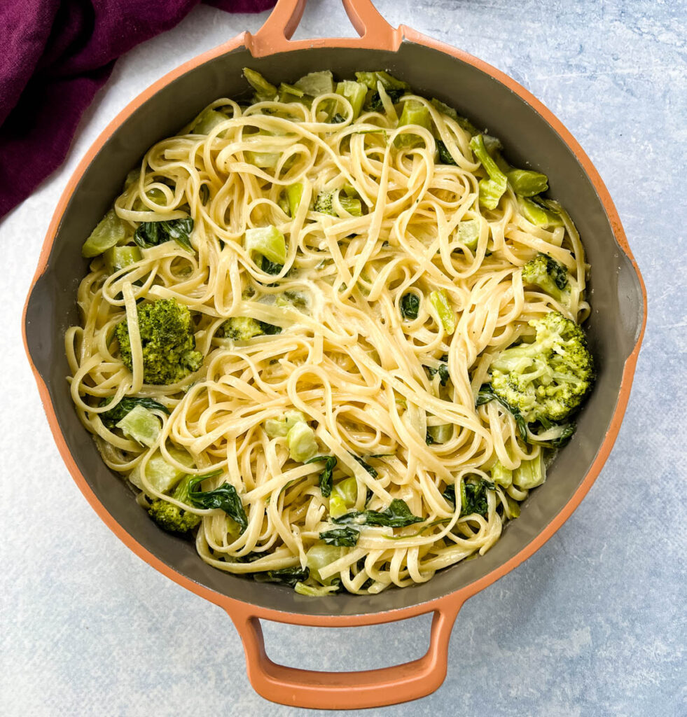 lemon pasta in a pan with spinach and broccoli