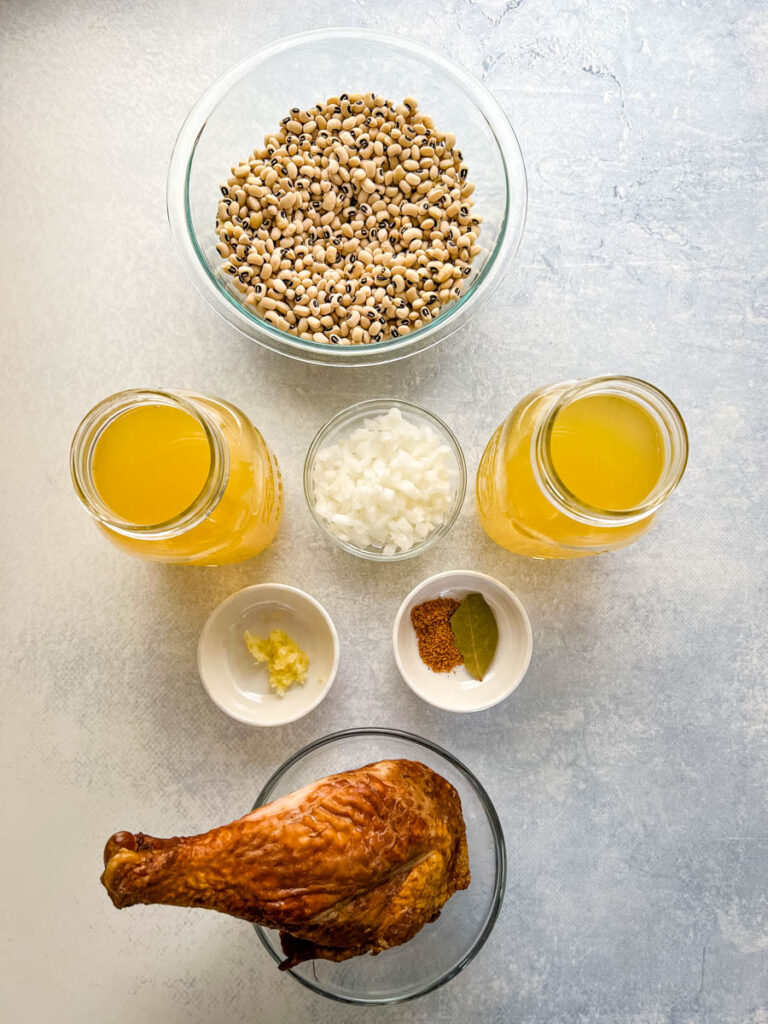 dried black eyed peas, broth, white onions, garlic, spices, and smoked turkey in separate bowls