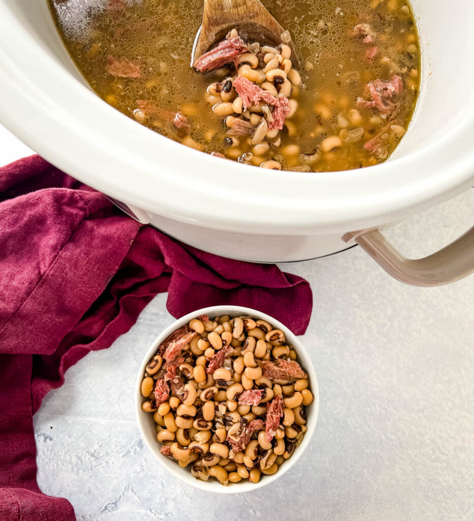 cooked black eyed peas in slow cooker Crockpot and a white bowl
