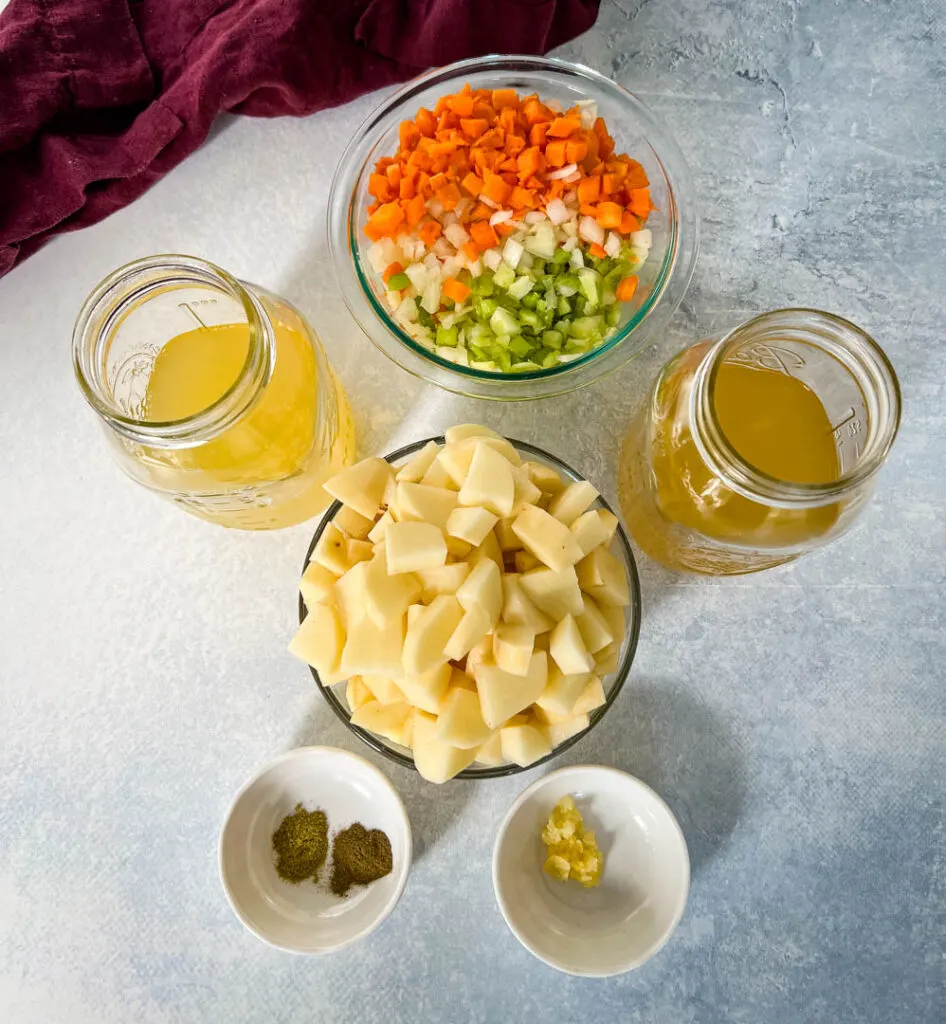 diced white potatoes, chopped veggies, broth, and spices in separate bowls