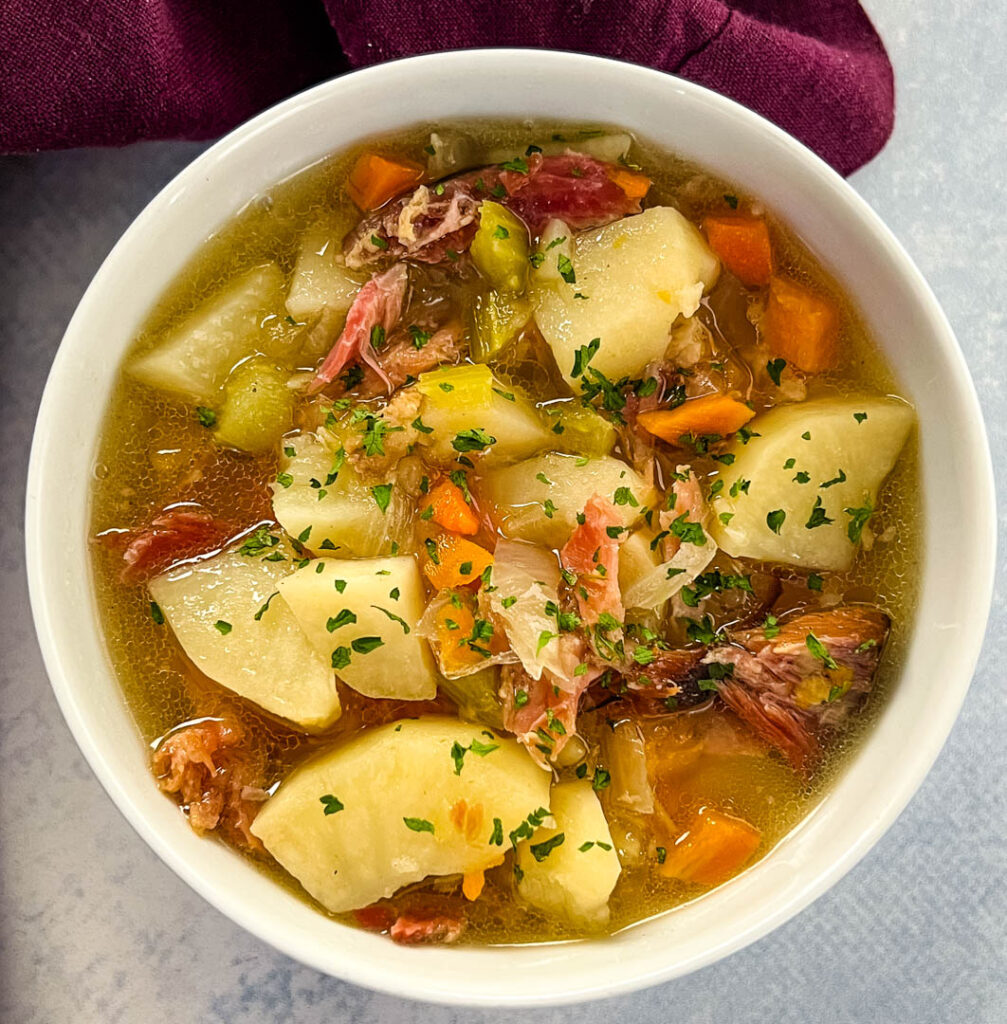 slow cooker crockpot ham and potato soup in a white bowl