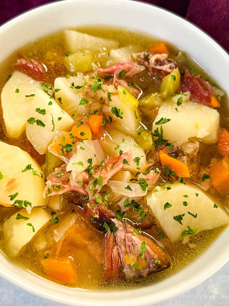 slow cooker crockpot ham and potato soup in a white bowl