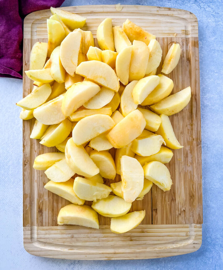 sliced apples on a bamboo cutting boad