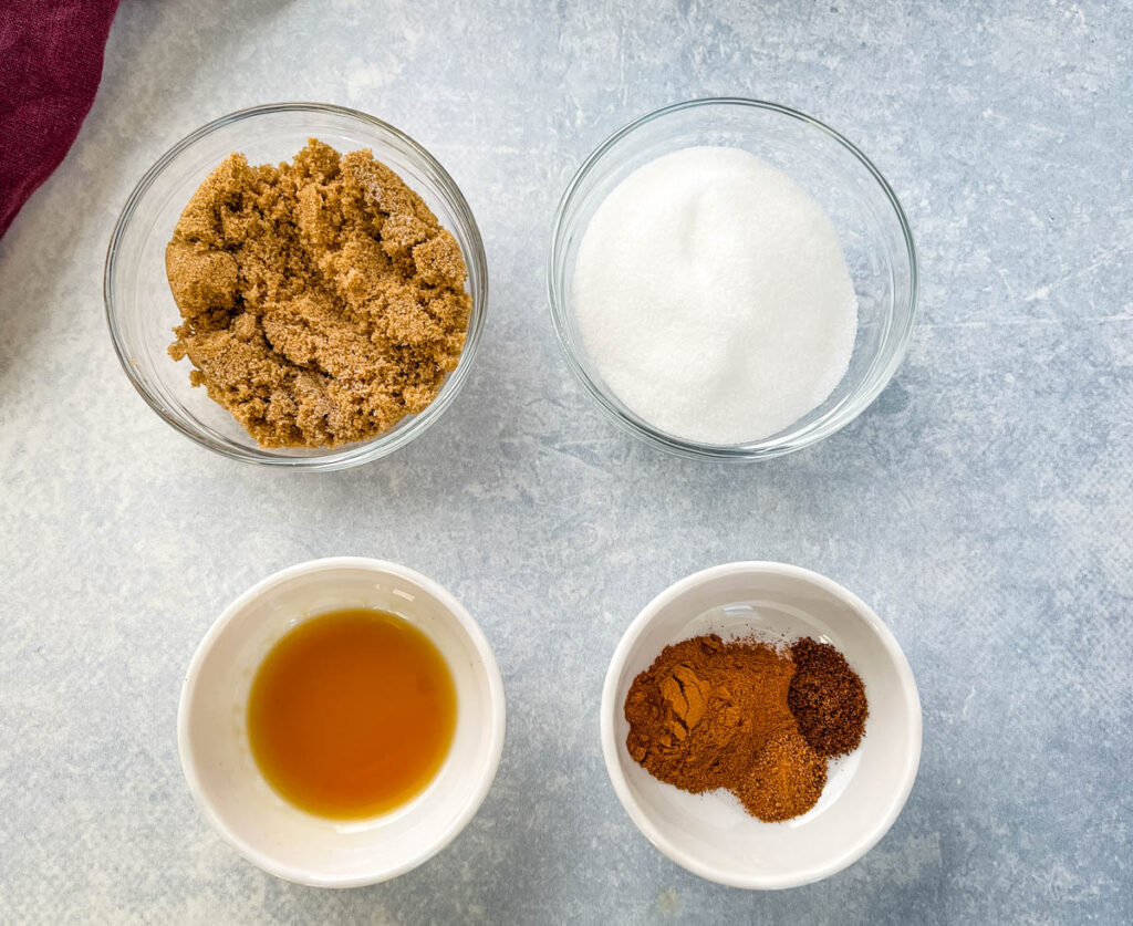 brown monkfruit, monkfruit sweetener, vanilla, cinnamon, cloves, and nutmeg in separate bowls