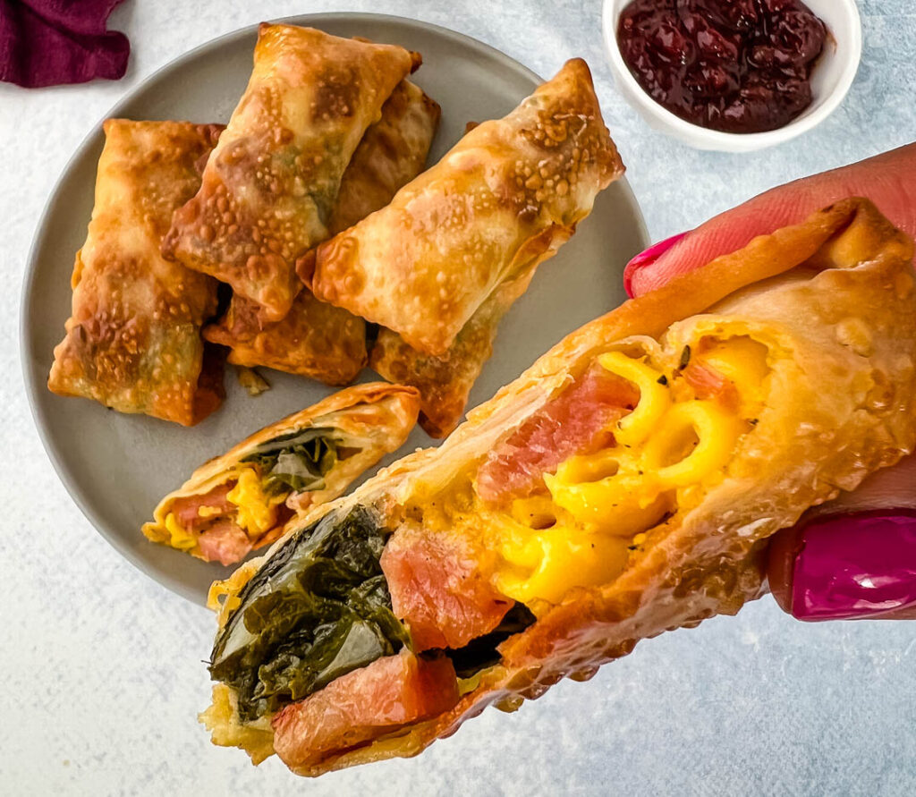 Thanksgiving soul food egg rolls held by a person