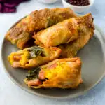 Thanksgiving soul food egg rolls sliced in half on a plate