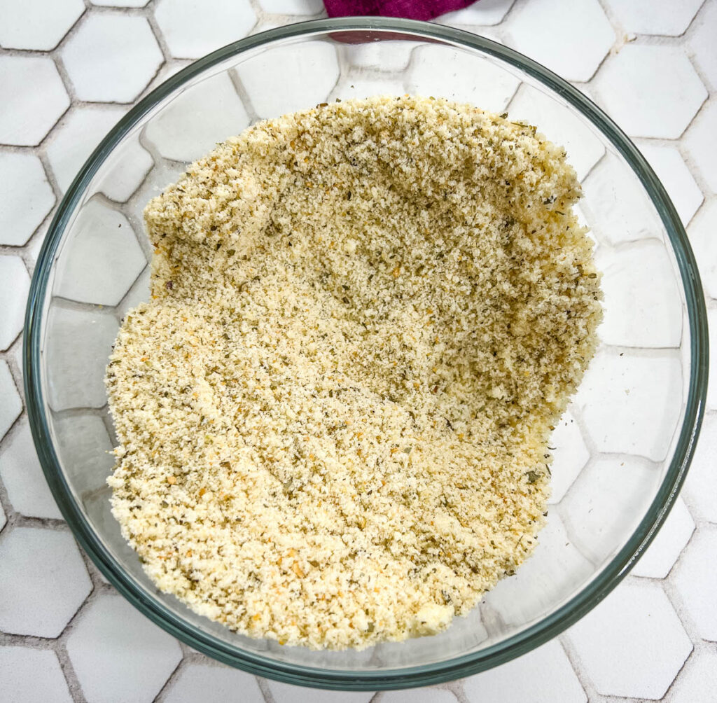 breadcrumbs and parmesan cheese in a glass bowl