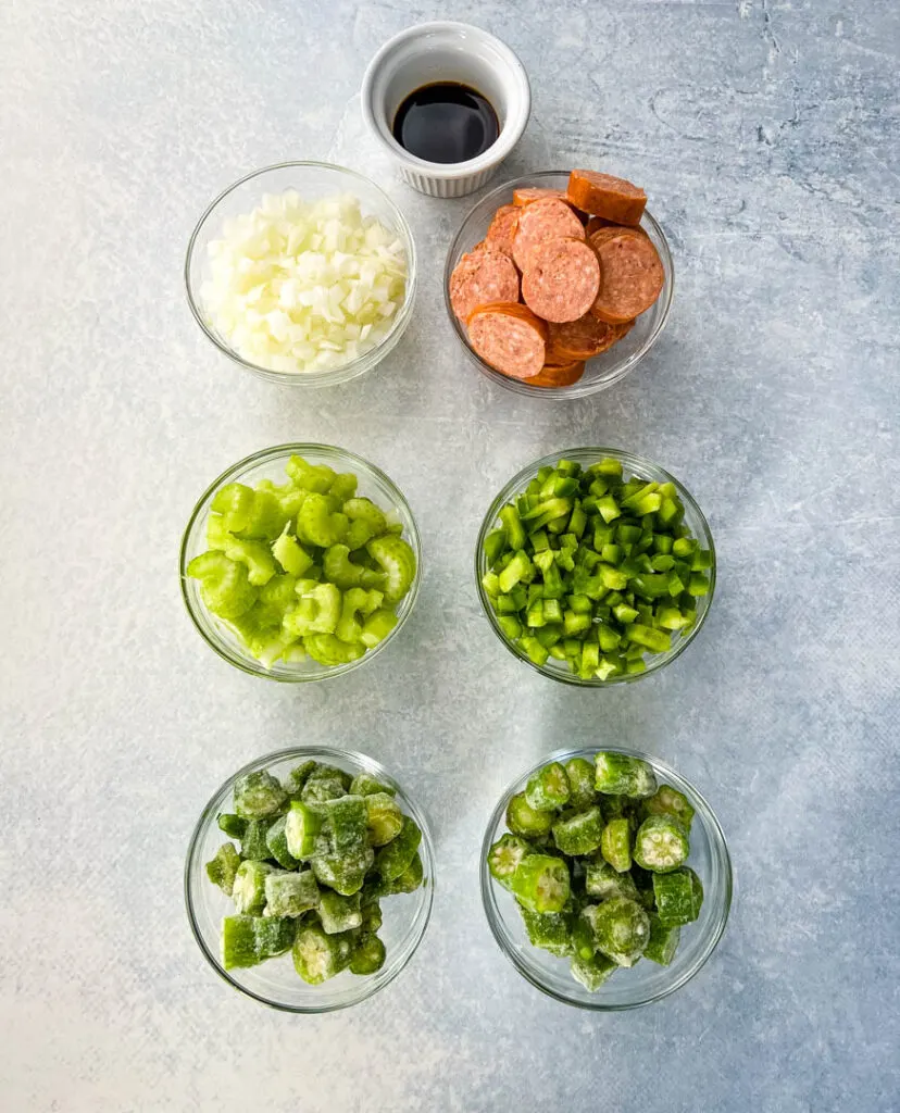 chopped onions, green peppers, celery, andouille sausage, okra, and worcestershire sauce in separate bowls