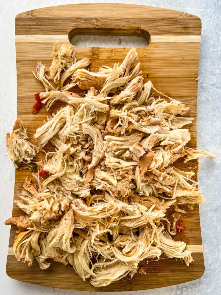 shredded chicken on a cutting board