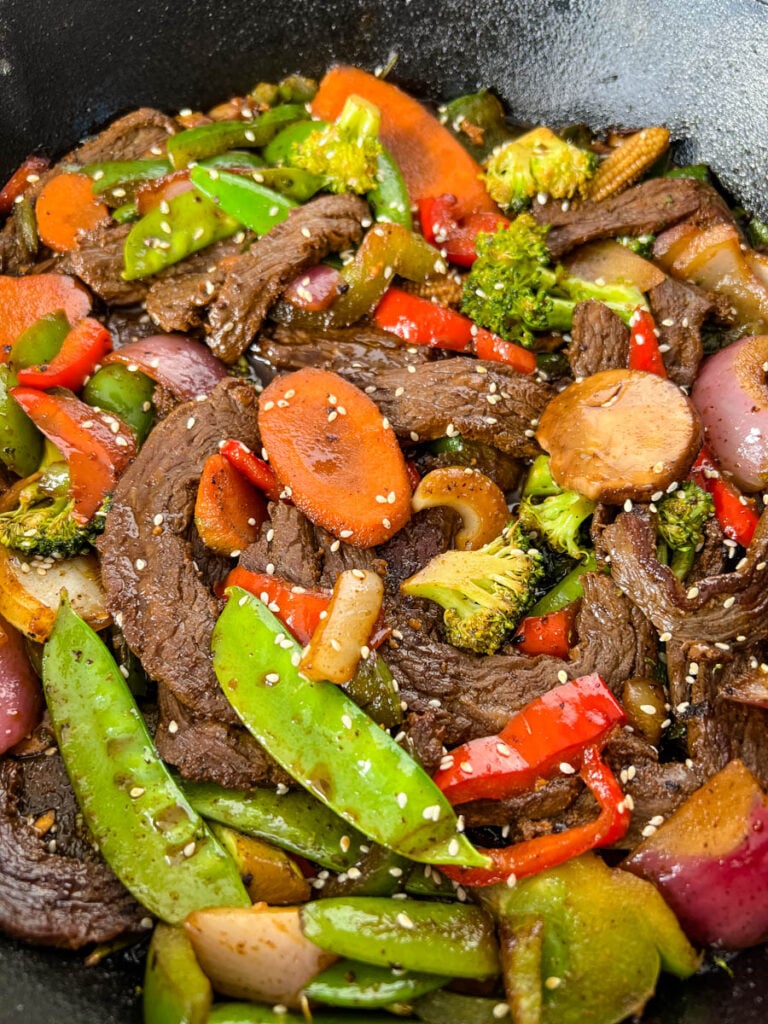 beef steak stir fry with vegetables in a skillet