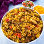 cheesy taco pasta in a white bowl