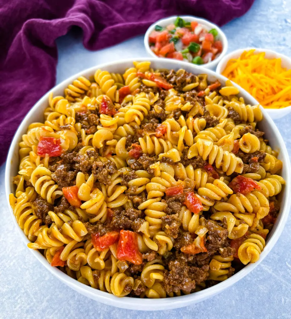 cheesy taco pasta in a white bowl