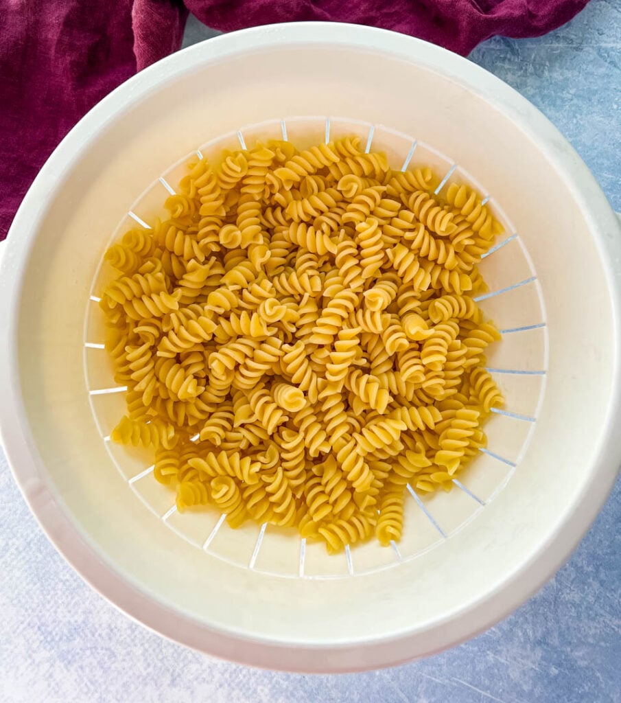 cooked rotini pasta in a colander