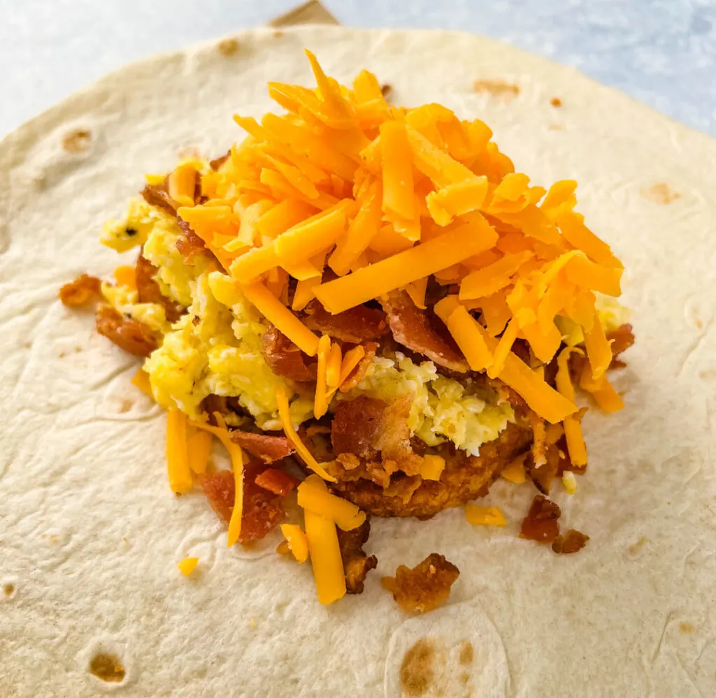 breakfast crunchwrap with cheese, hashbrowns, eggs, and bacon