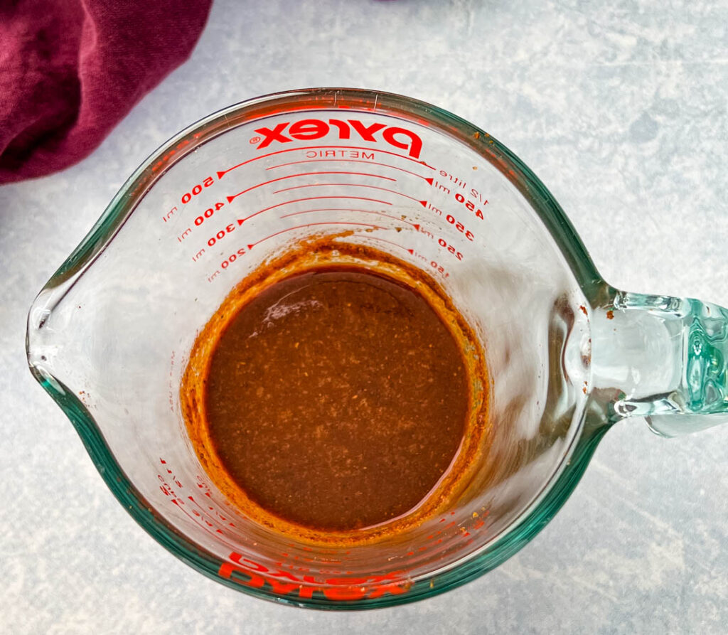 jerk marinade in a glass measuring cup