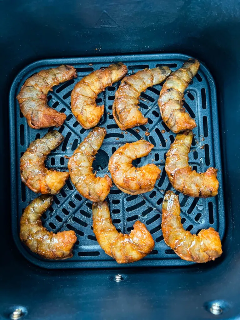 raw jerk shrimp in air fryer basket