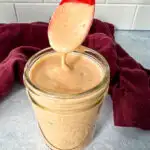 a spoonful of southwest salad dressing in a glass jar