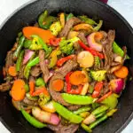 steak stir fry in a cast iron skillet