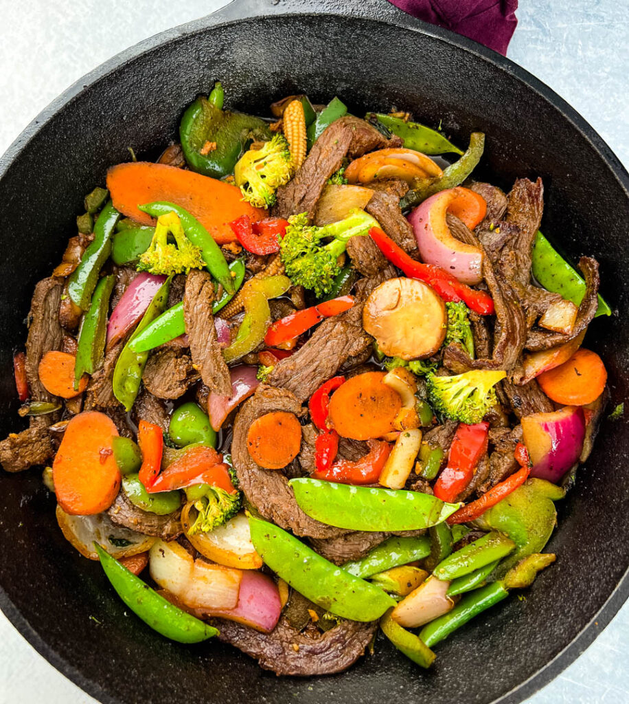 steak stir fry in a cast iron skillet