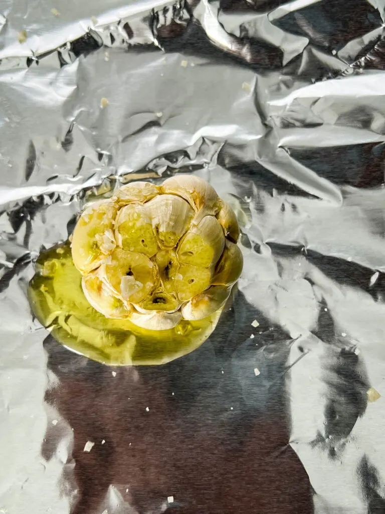 garlic on foil drizzled with olive oil