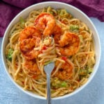 bang bang shrimp pasta in a white bowl with a fork