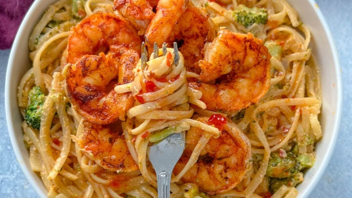 bang bang shrimp pasta in a white bowl with a fork