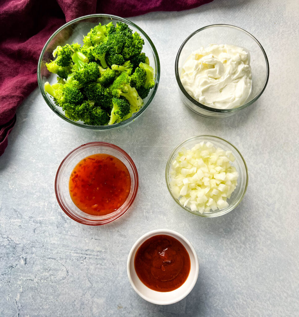cooked broccoli, Greek yogurt, sweet chili sauce, onions, and Sriracha in separate bowls